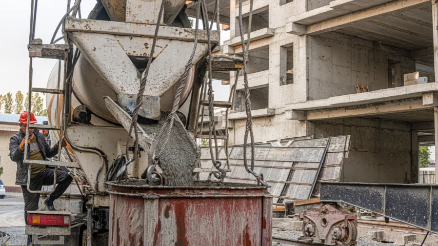 Workers pouring ready mix concrete at a construction site
